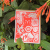 neon red cat in a garden greeting card