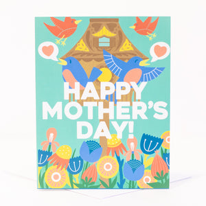 spring mothers day card with a birdhouse flowers and singing birds