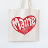 Tote bag with a red heart-shaped design featuring the word 'Maine' on a white background