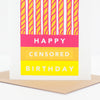 A birthday greeting card with a graphic of nine pink and yellow striped candles above the words 'HAPPY CENSORED BIRTHDAY' in white text on pink, yellow, and blue blocks. The card is shown standing upright on a brown envelope against a clean white background.
