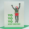 A Christmas greeting card with a green envelope, featuring a graphic of a boxer in red shorts and a Santa hat with green holiday lights, alongside the text 'YO YO YO MERRY CHRISTMAS' in green.