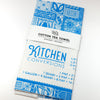 Cotton tea towel with blue patterns and 'Kitchen Conversions' text on a white background