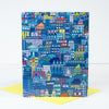 Colorful cityscape patterned card with a yellow envelope on a white background
