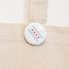 Button with Chicago flag design on a beige background
