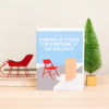 funny city parking christmas card by exit343design featuring a folding chair saving Santa's parking spot on a roof