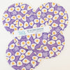 Set of four purple coasters with egg pattern.