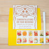 Wedding card with bird design and floral stamps on a yellow envelope.