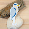 Sticker of a heron on a shell with driftwood