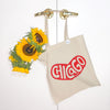 Beige tote bag with 'Chicago' design and sunflowers on a white background