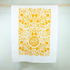 White towel with yellow pasta-themed pattern and 'more pasta please' text on a white background