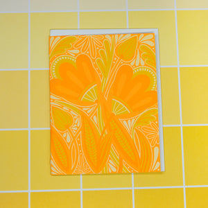 Floral patterned card on a yellow tiled background