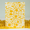 Yellow pasta patterned box with pasta on a white background