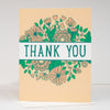 Card with floral design and 'Thank You' text on a beige background