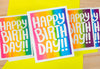 Colorful 'Happy Birthday!' cards on a yellow background