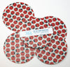 Set of four ladybug pattern coasters with a visible brand label on a white background