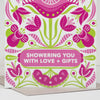 Greeting card with pink and green floral design and text 'Showering you with love + gifts'.