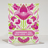 Greeting card with floral design and text 'Showering you with love + gifts' on a white background