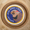 Sticker with a bird illustration and 'Support Local Birds + Bugs' text on a wooden background