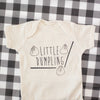 Little dumpling baby onesie with three dumplings and a set of chopsticks in black ink on a tan bodysuit