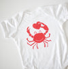 Maryland crab holding a red heart on a baby onesie