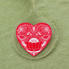 red heart Christmas tree ornament in a folk art style